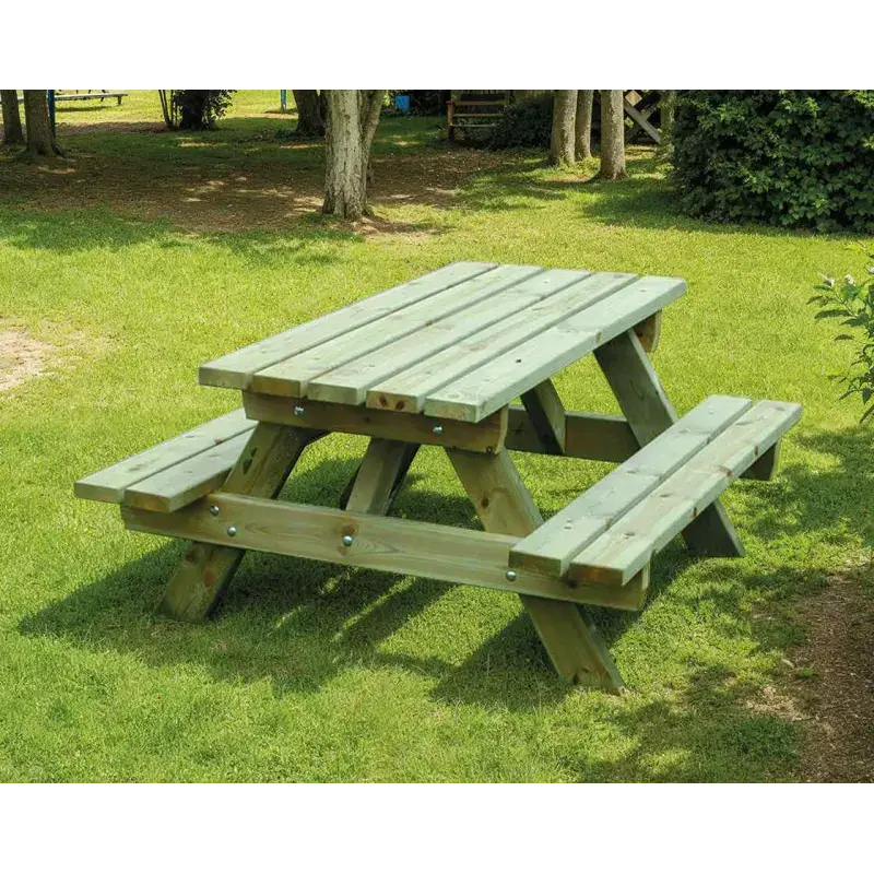 Table de pique-nique en bois traité dans un jardin verdoyant